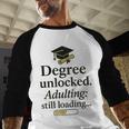 Graduation 2025 Degree Unlocked Adulting Still Loading Baseball Raglan Shirt