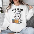 Unearth a Story Cute Dinosaur Summer Reading 2026 Dino Book Unisex Sweatshirt Unearth a Story Cute Dinosaur Summer Reading 2026 Dino Book Unisex Sweatshirt