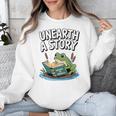 Unearth a Story Frog Reading a Book Summer 2026 Premium Tri-Blend Unisex Sweatshirt Unearth a Story Frog Reading a Book Summer 2026 Premium Tri-Blend Unisex Sweatshirt