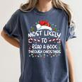 Most Likely To Read A Book Through Christmas Xmas Women's Comfort Colors T-Shirt Moss