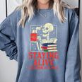 Staying Alive One Book At A Time Skeleton Reading Librarian Comfort Colors Sweatshirt Denim