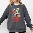Staying Alive One Book At A Time Skeleton Reading Librarian Comfort Colors Sweatshirt Pepper