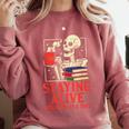 Staying Alive One Book At A Time Skeleton Reading Librarian Comfort Colors Sweatshirt Orchid
